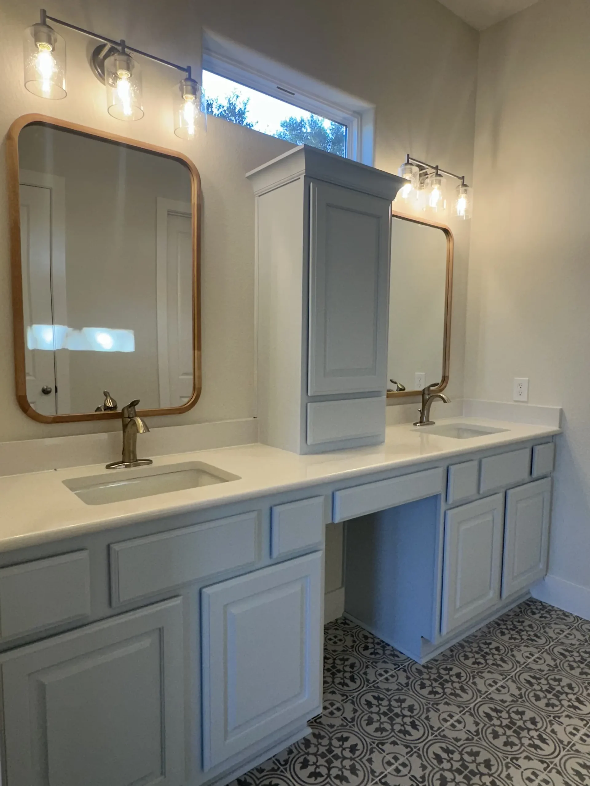 Custom home master bathroom with a long double vanity and light blue cabinets