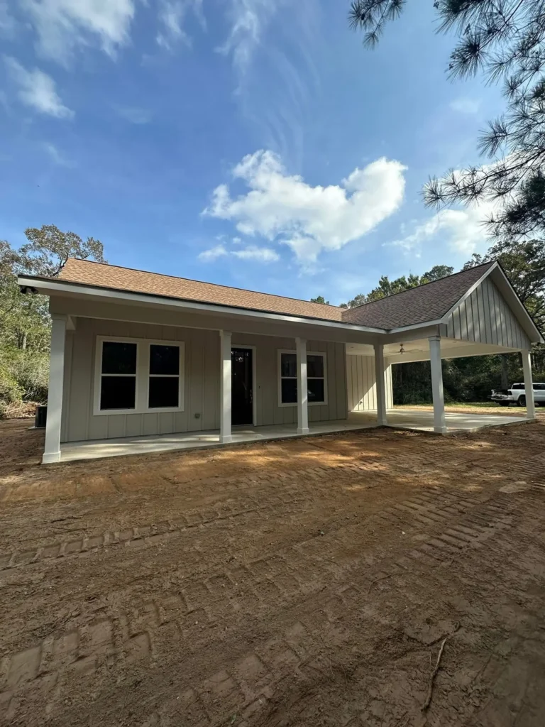 Rear exterior of a custom home with a covered patio and paver flooring