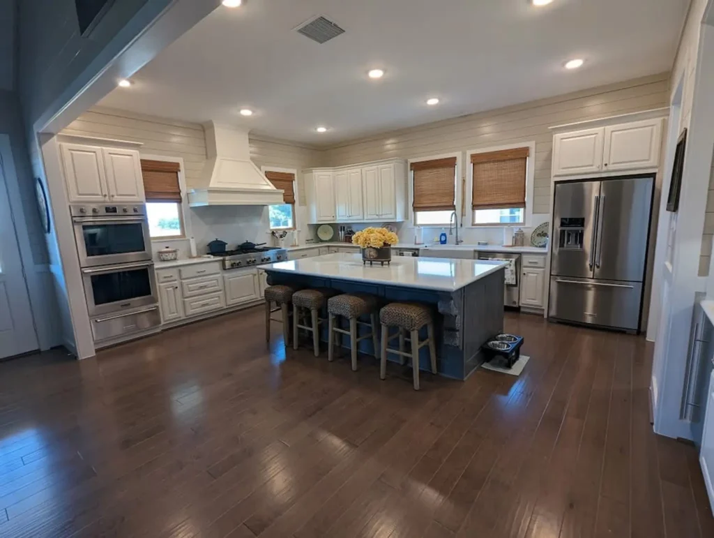 Spacious custom home kitchen with a center island, bar seating and stainless appliances