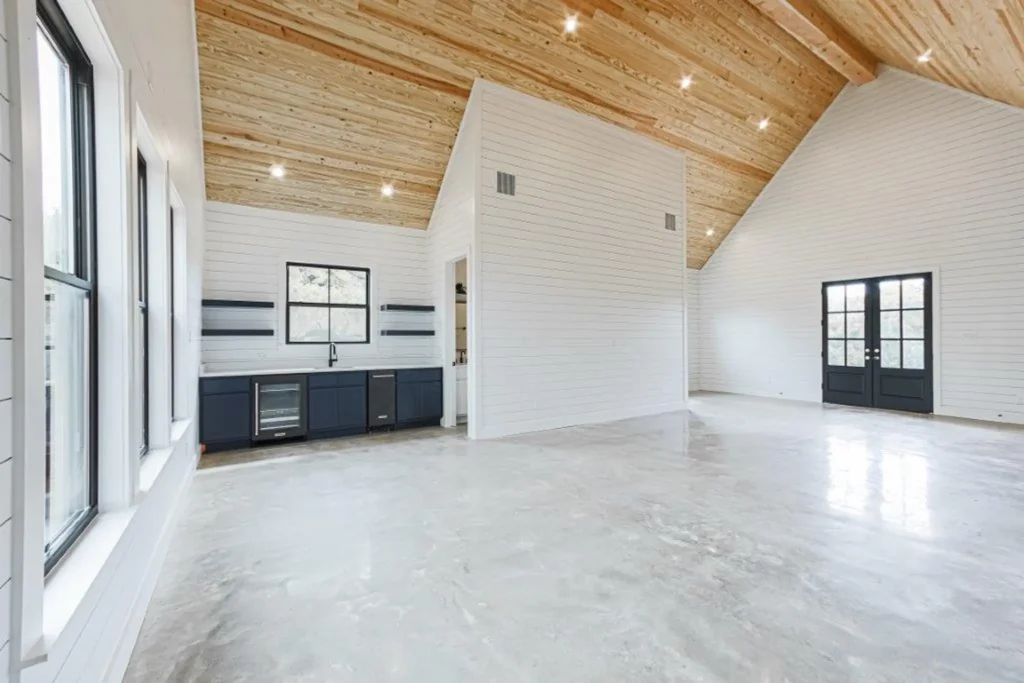 Custom home great room with a vaulted wood-plank ceiling and built-in cabinets